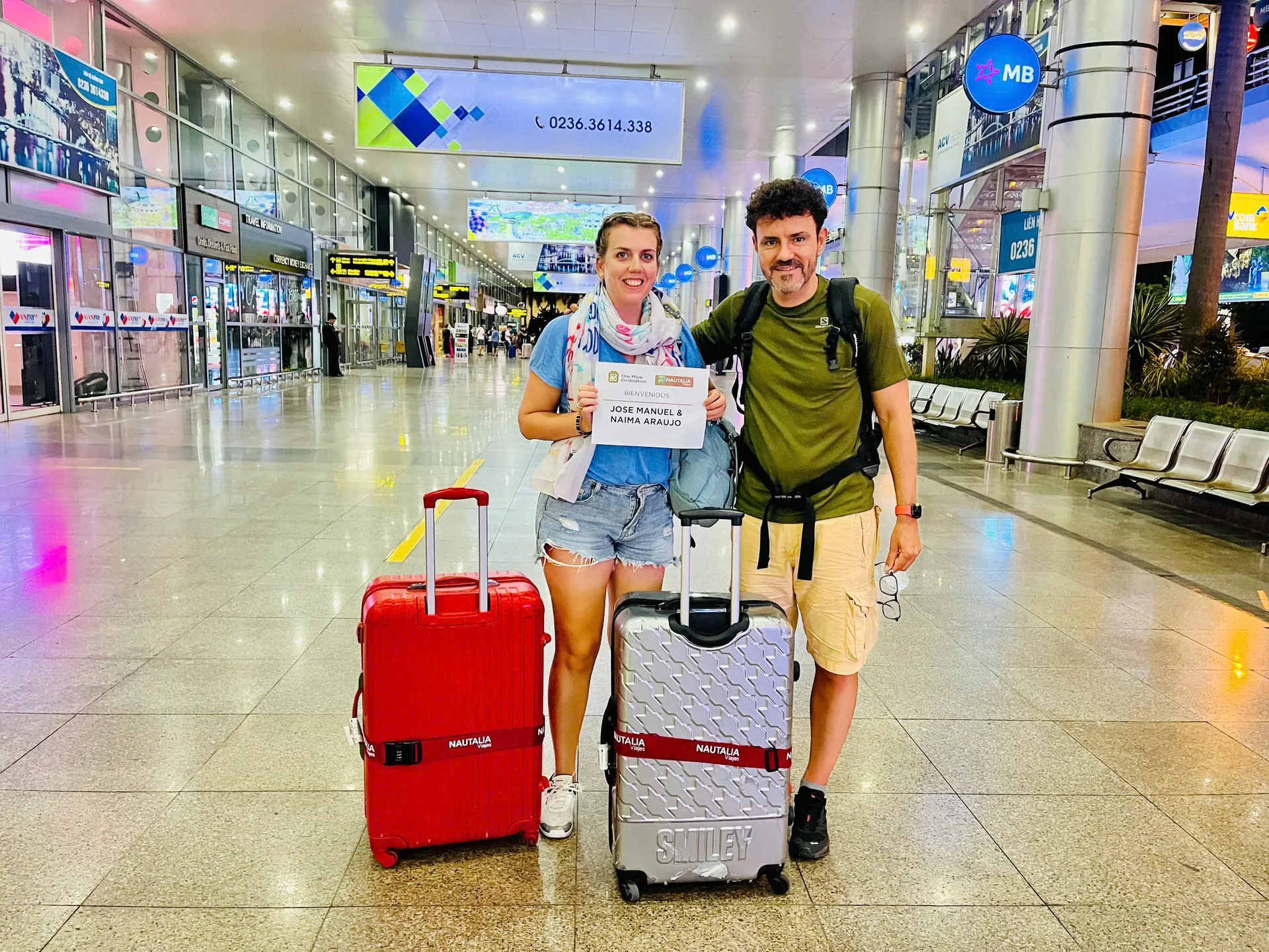 Mr. Dũng welcoming guests at Da Nang Airport with welcome sign